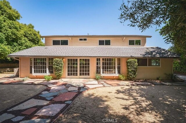 2521 Wildrose Ln, Upland, CA 91784 - back of property with stucco siding, a patio, and a shingled roof
