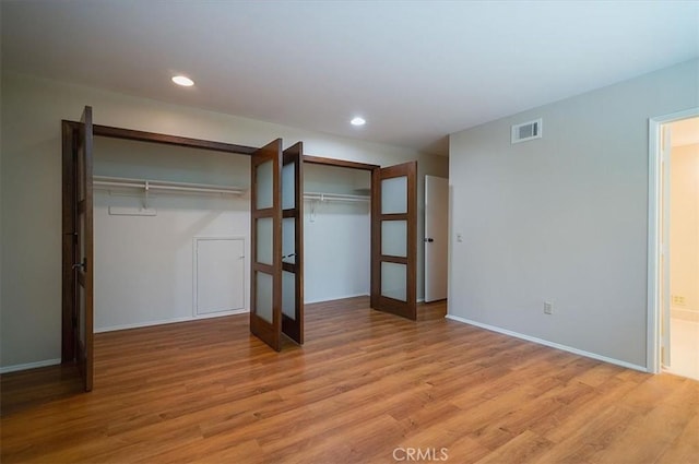 2521 Wildrose Ln, Upland, CA 91784 - unfurnished bedroom featuring french doors, light wood finished floors, recessed lighting, and ensuite bathroom