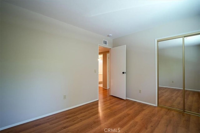 2521 Wildrose Ln, Upland, CA 91784 - unfurnished bedroom with wood finished floors and a closet