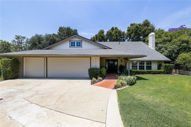 2521 Wildrose Ln, Upland, CA 91784 - view of front of property featuring concrete driveway, an attached garage, a front lawn, a chimney, and board and batten siding