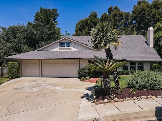 2521 Wildrose Ln, Upland, CA 91784 - view of front of property with a chimney, a garage, concrete driveway, and a shingled roof