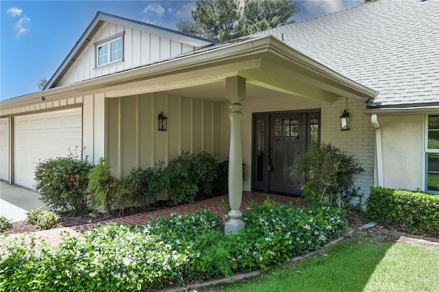 2521 Wildrose Ln, Upland, CA 91784 - property entrance with board and batten siding, roof with shingles, brick siding, an attached garage, and driveway