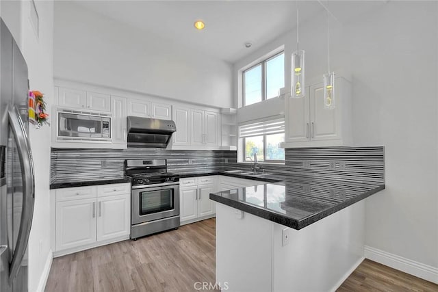 600 N Atlantic Blvd Unit 209, Monterey Park, CA 91754 - kitchen featuring appliances with stainless steel finishes, a peninsula, a sink, dark countertops, and a high ceiling