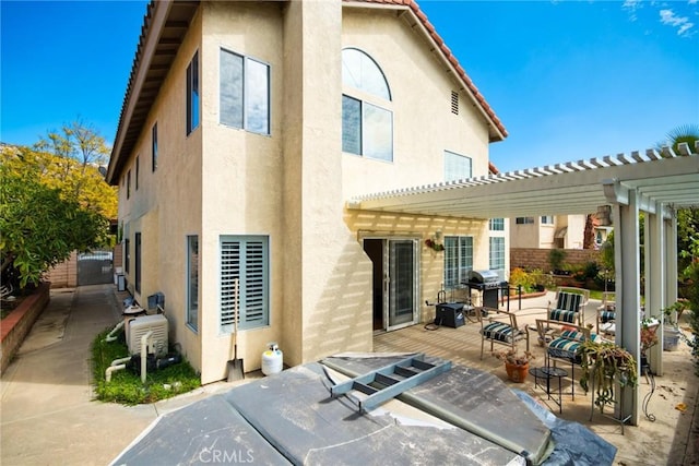 9615 Shadow Springs Dr, Moreno Valley, CA 92557 - rear view of house featuring stucco siding, a pergola, and a patio area