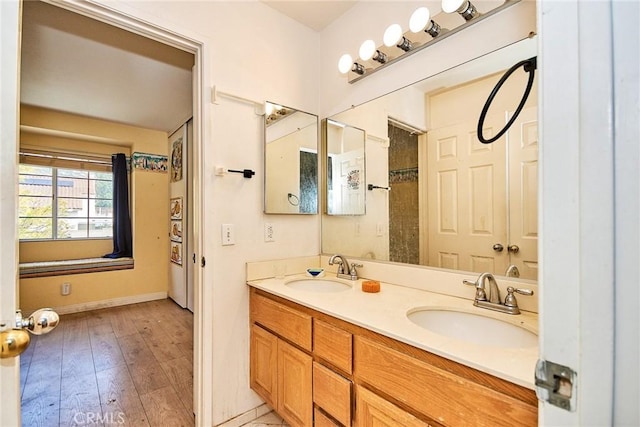 9615 Shadow Springs Dr, Moreno Valley, CA 92557 - full bath featuring baseboards, double vanity, and hardwood / wood-style flooring
