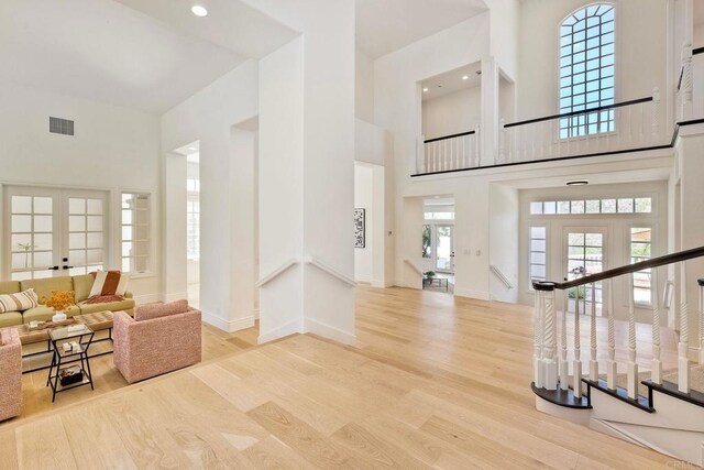 6039 Calle Camposeco, Rancho Santa Fe, CA 92067 - unfurnished living room with a towering ceiling, wood finished floors, baseboards, stairway, and recessed lighting