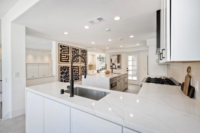 6039 Calle Camposeco, Rancho Santa Fe, CA 92067 - kitchen with a sink, light stone countertops, recessed lighting, decorative backsplash, and white cabinetry