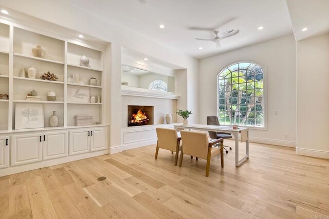 6039 Calle Camposeco, Rancho Santa Fe, CA 92067 - office space featuring light wood-style floors, a warm lit fireplace, recessed lighting, ceiling fan, and baseboards