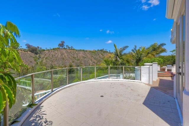 6039 Calle Camposeco, Rancho Santa Fe, CA 92067 - view of patio with an outdoor hot tub, a mountain view, and a balcony