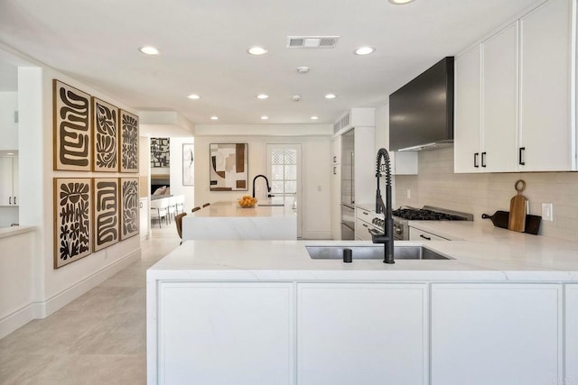 6039 Calle Camposeco, Rancho Santa Fe, CA 92067 - kitchen featuring a sink, light stone countertops, white cabinetry, decorative backsplash, and recessed lighting