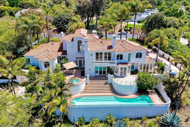 6039 Calle Camposeco, Rancho Santa Fe, CA 92067 - back of house featuring an in-ground hot tub, an outdoor pool, french doors, a tile roof, and a patio area