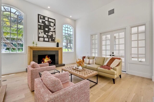 6039 Calle Camposeco, Rancho Santa Fe, CA 92067 - living area with light wood finished floors, a warm lit fireplace, baseboards, and recessed lighting