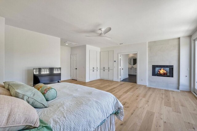 6039 Calle Camposeco, Rancho Santa Fe, CA 92067 - bedroom featuring wood finished floors, baseboards, a fireplace, and a ceiling fan