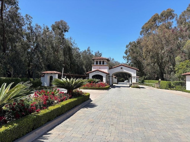 6039 Calle Camposeco, Rancho Santa Fe, CA 92067 - mediterranean / spanish home featuring curved driveway and stucco siding