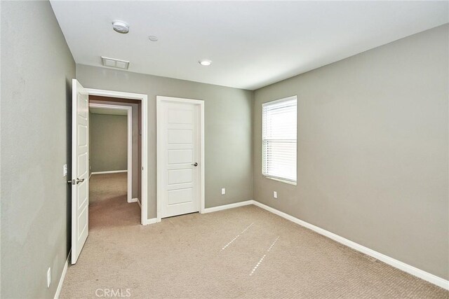 894 Harvest Ave, Upland, CA 91786 - unfurnished bedroom featuring baseboards and light carpet