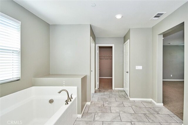 894 Harvest Ave, Upland, CA 91786 - full bath featuring a garden tub, a spacious closet, and baseboards