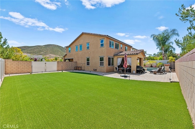 36438 Geranium Dr, Lake Elsinore, CA 92532 - rear view of property featuring a patio area, stucco siding, a mountain view, and a gate