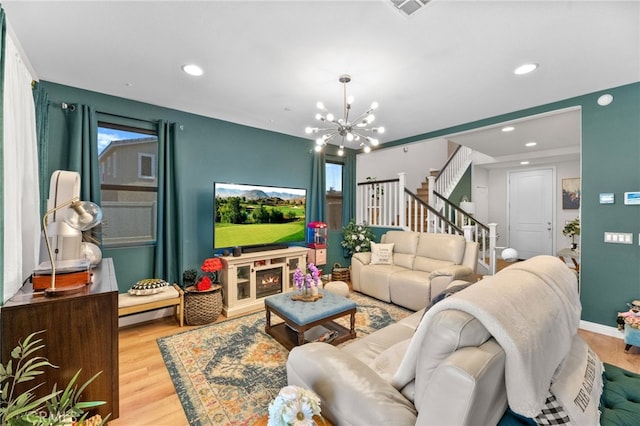 36438 Geranium Dr, Lake Elsinore, CA 92532 - living room featuring wood finished floors, a chandelier, stairway, recessed lighting, and baseboards