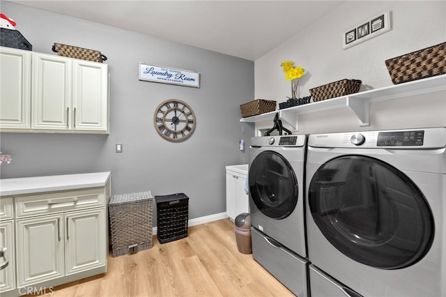 36438 Geranium Dr, Lake Elsinore, CA 92532 - clothes washing area with cabinet space, washer and clothes dryer, light wood-style floors, and baseboards
