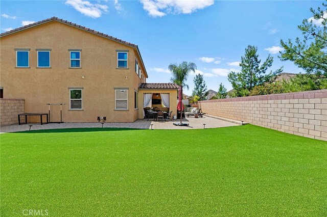 36438 Geranium Dr, Lake Elsinore, CA 92532 - back of house featuring a patio area, a fenced backyard, and stucco siding