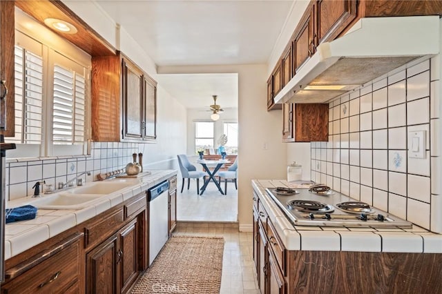 872 W 21st St, San Pedro, CA 90731 - kitchen featuring under cabinet range hood, tile counters, appliances with stainless steel finishes, a ceiling fan, and tasteful backsplash