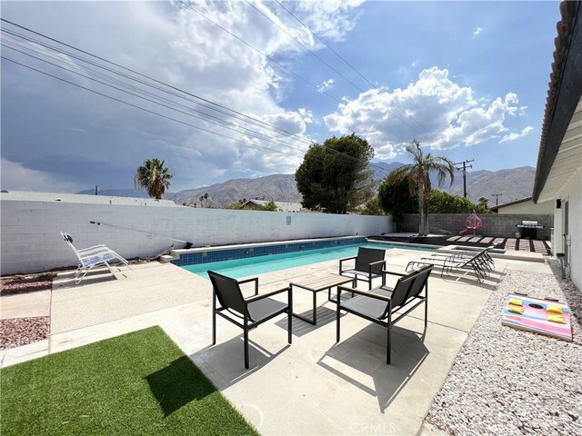 445 E San Rafael Dr, Palm Springs, CA 92262 - view of swimming pool with a fenced backyard, a mountain view, and a patio area