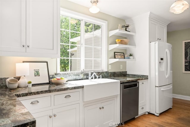 921 Arbutus Ave, Chico, CA 95926 - kitchen featuring white fridge with ice dispenser, stainless steel dishwasher, open shelves, white cabinets, and light wood finished floors
