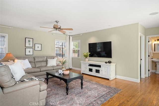 921 Arbutus Ave, Chico, CA 95926 - living room with ceiling fan, baseboards, and light wood finished floors