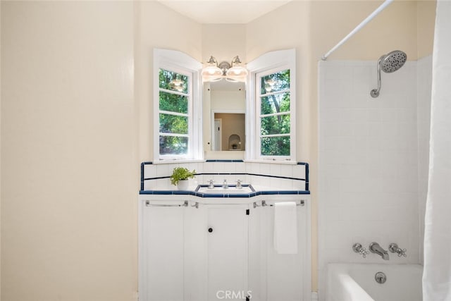 921 Arbutus Ave, Chico, CA 95926 - bathroom with decorative backsplash, shower / bath combo, and vanity