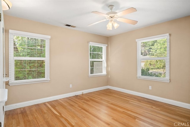 921 Arbutus Ave, Chico, CA 95926 - empty room featuring healthy amount of natural light, light wood finished floors, baseboards, and a ceiling fan