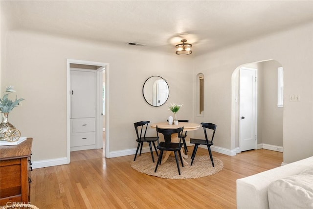 921 Arbutus Ave, Chico, CA 95926 - dining room with arched walkways, light wood-style floors, and baseboards