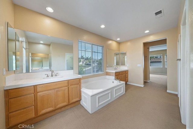 32475 Corte Barela, Temecula, CA 92592 - bathroom with two vanities, plenty of natural light, a garden tub, recessed lighting, and baseboards