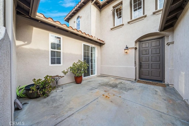 32475 Corte Barela, Temecula, CA 92592 - entrance to property with stucco siding, a patio area, and a tile roof
