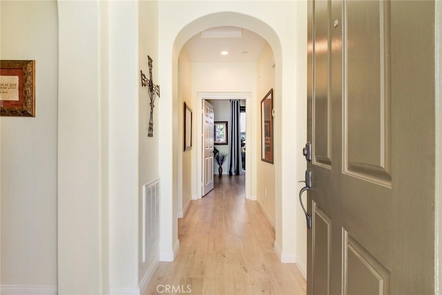 4329 Junction St Unit 103, Corona, CA 92883 - corridor featuring arched walkways, light wood-style flooring, and baseboards