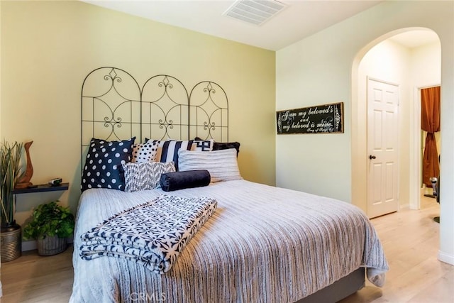 4329 Junction St Unit 103, Corona, CA 92883 - bedroom featuring arched walkways and wood finished floors