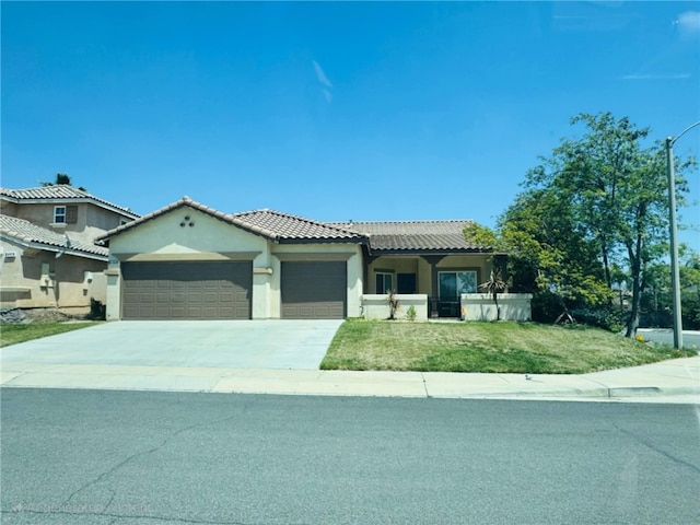 1312 Daylily Dr, Beaumont, CA 92223 - view of front of home featuring an attached garage, driveway, stucco siding, a tile roof, and a front yard