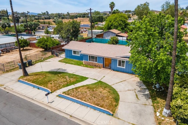 1030 Perrisito St, Perris, CA 92570 - ranch-style house with board and batten siding, fence, and driveway