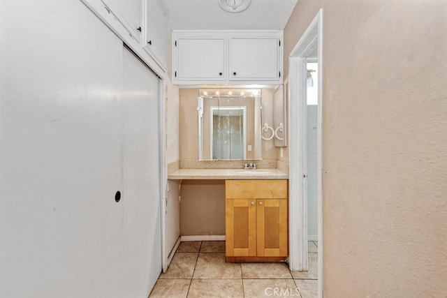 1030 Perrisito St, Perris, CA 92570 - bathroom with tile patterned floors, vanity, and baseboards