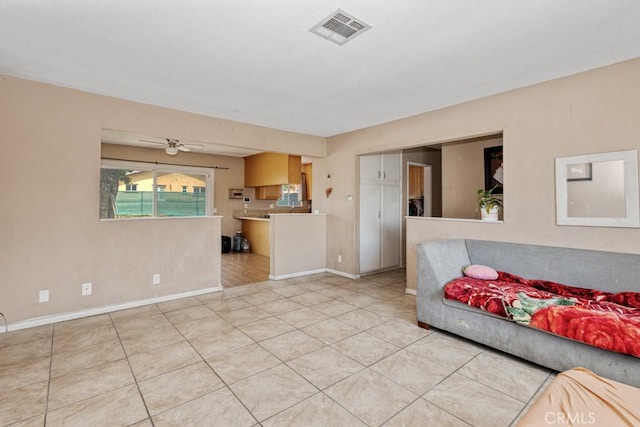 1030 Perrisito St, Perris, CA 92570 - unfurnished living room featuring baseboards, light tile patterned floors, and ceiling fan