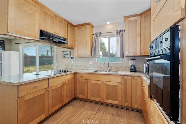 1030 Perrisito St, Perris, CA 92570 - kitchen featuring under cabinet range hood, a sink, light wood-type flooring, a peninsula, and black appliances