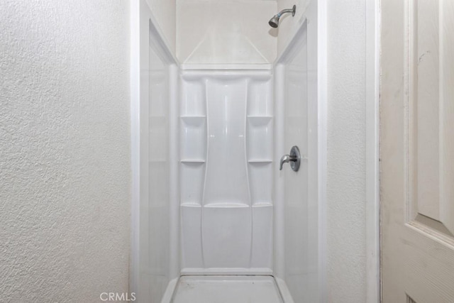 1030 Perrisito St, Perris, CA 92570 - full bathroom featuring a textured wall and a shower stall
