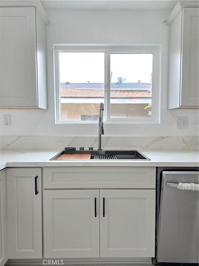 140 E Colden Ave, Los Angeles, CA 90003 - kitchen with stainless steel dishwasher, a sink, and white cabinets
