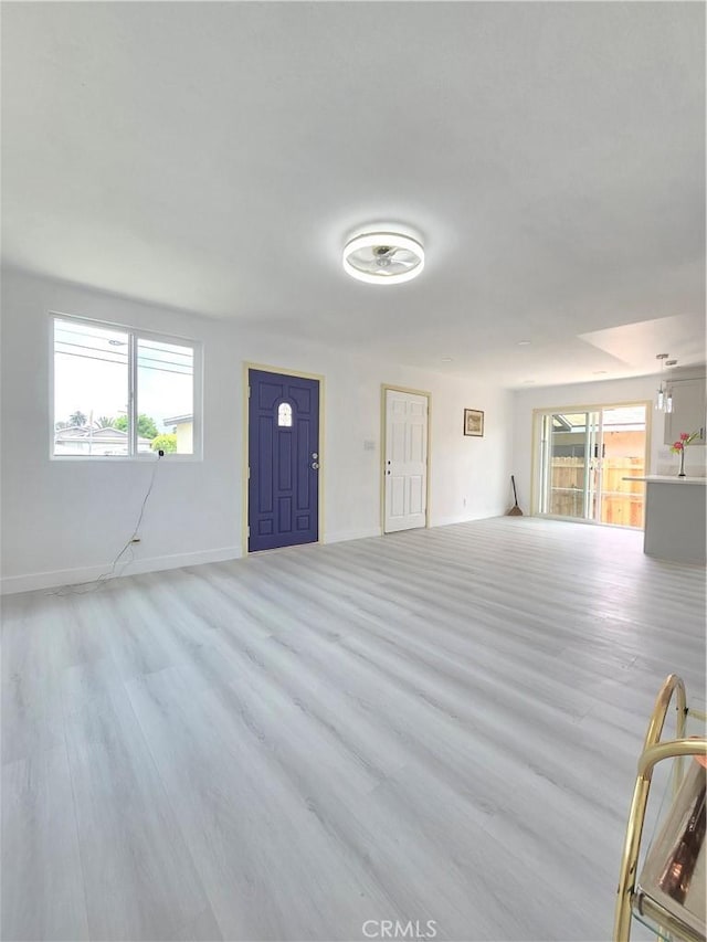 140 E Colden Ave, Los Angeles, CA 90003 - unfurnished living room with plenty of natural light, wood finished floors, and baseboards