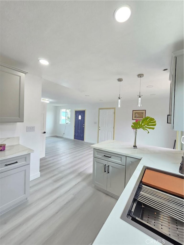 140 E Colden Ave, Los Angeles, CA 90003 - kitchen with open floor plan, light wood-style flooring, light countertops, decorative light fixtures, and recessed lighting