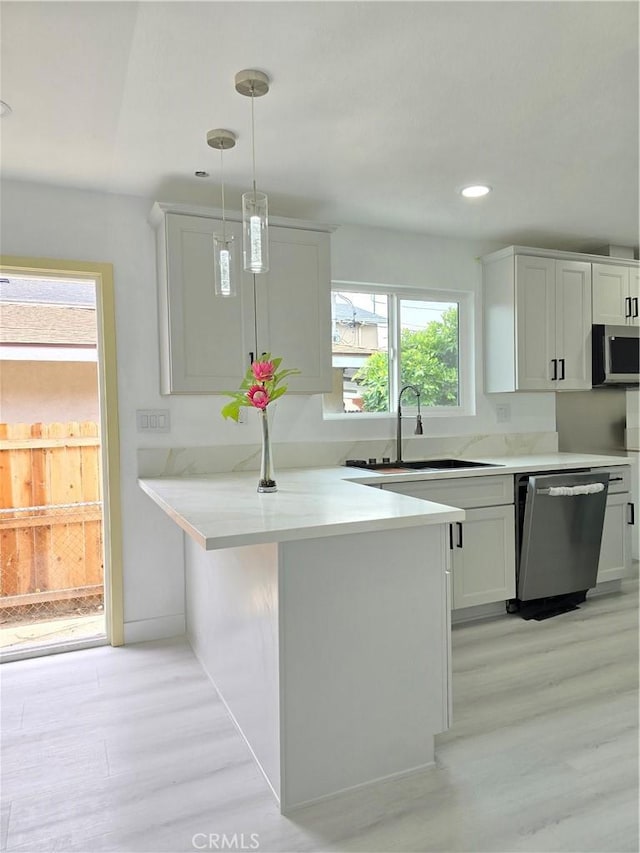 140 E Colden Ave, Los Angeles, CA 90003 - kitchen featuring a sink, stainless steel appliances, light wood-style flooring, light countertops, and recessed lighting