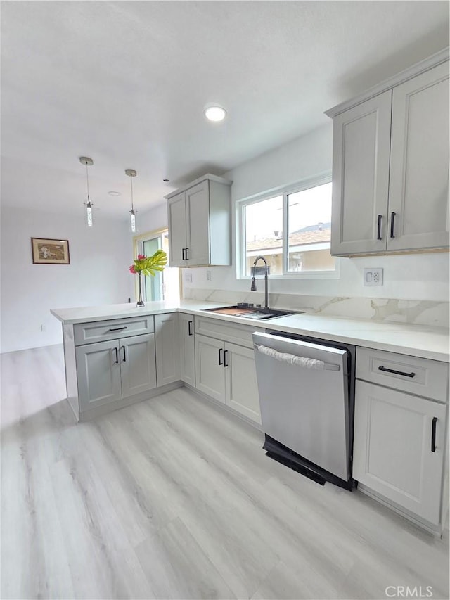 140 E Colden Ave, Los Angeles, CA 90003 - kitchen featuring stainless steel dishwasher, a sink, a peninsula, gray cabinetry, and light wood finished floors