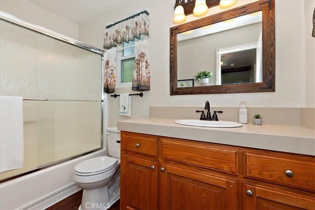 145 Cumberland Dr, Lake Arrowhead, CA 92352 - bathroom featuring toilet, vanity, and enclosed tub / shower combo