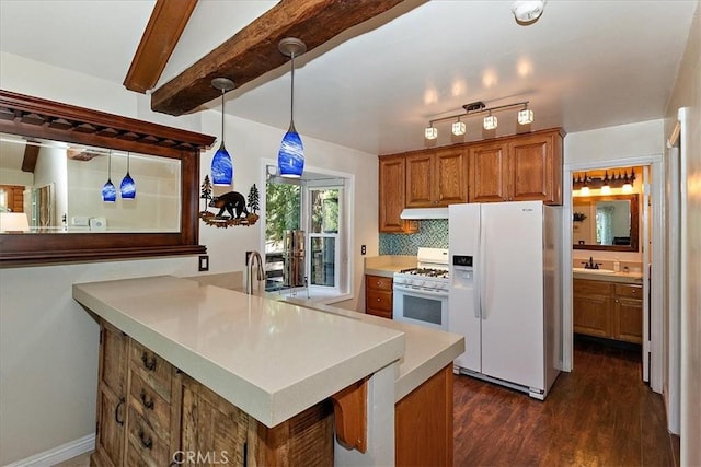 145 Cumberland Dr, Lake Arrowhead, CA 92352 - kitchen featuring white appliances, brown cabinetry, a sink, dark wood-style flooring, and light countertops