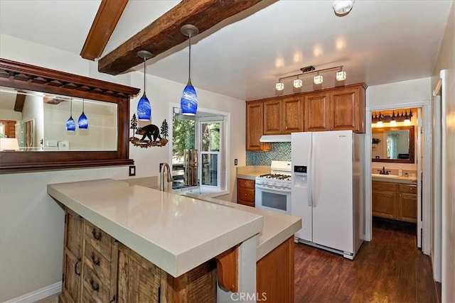 145 Cumberland Dr, Lake Arrowhead, CA 92352 - kitchen featuring white appliances, brown cabinets, dark wood finished floors, light countertops, and under cabinet range hood