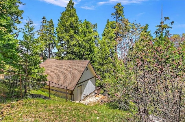145 Cumberland Dr, Lake Arrowhead, CA 92352 - view of side of property featuring fence, an outbuilding, and roof with shingles